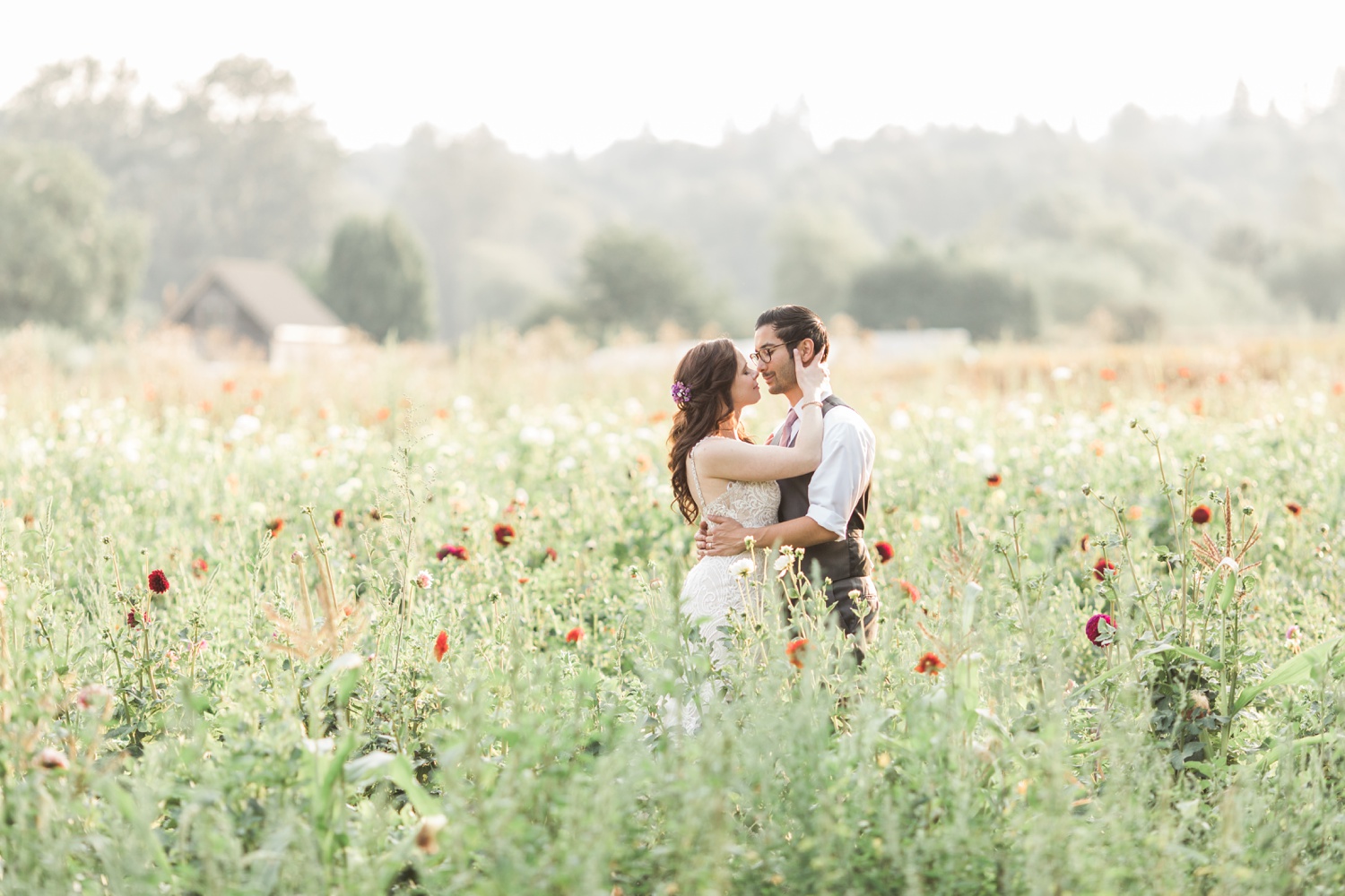 A bride and groom kiss in a field of flowers before their wedding at Woodland Meadow Farms in Snohomish, a wedding venue near Seattle, WA. | Joanna Monger Photography | Seattle & Snohomish Photographer